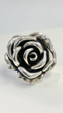 Load image into Gallery viewer, A sterling silver ring sculpted in the shape of a rose, photographed on a plain light gray background.