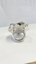 Load image into Gallery viewer, A silver ring with a sculptural, organic shape resembling a stylized animal head or abstract form, photographed on a plain white surface with a light gray background.